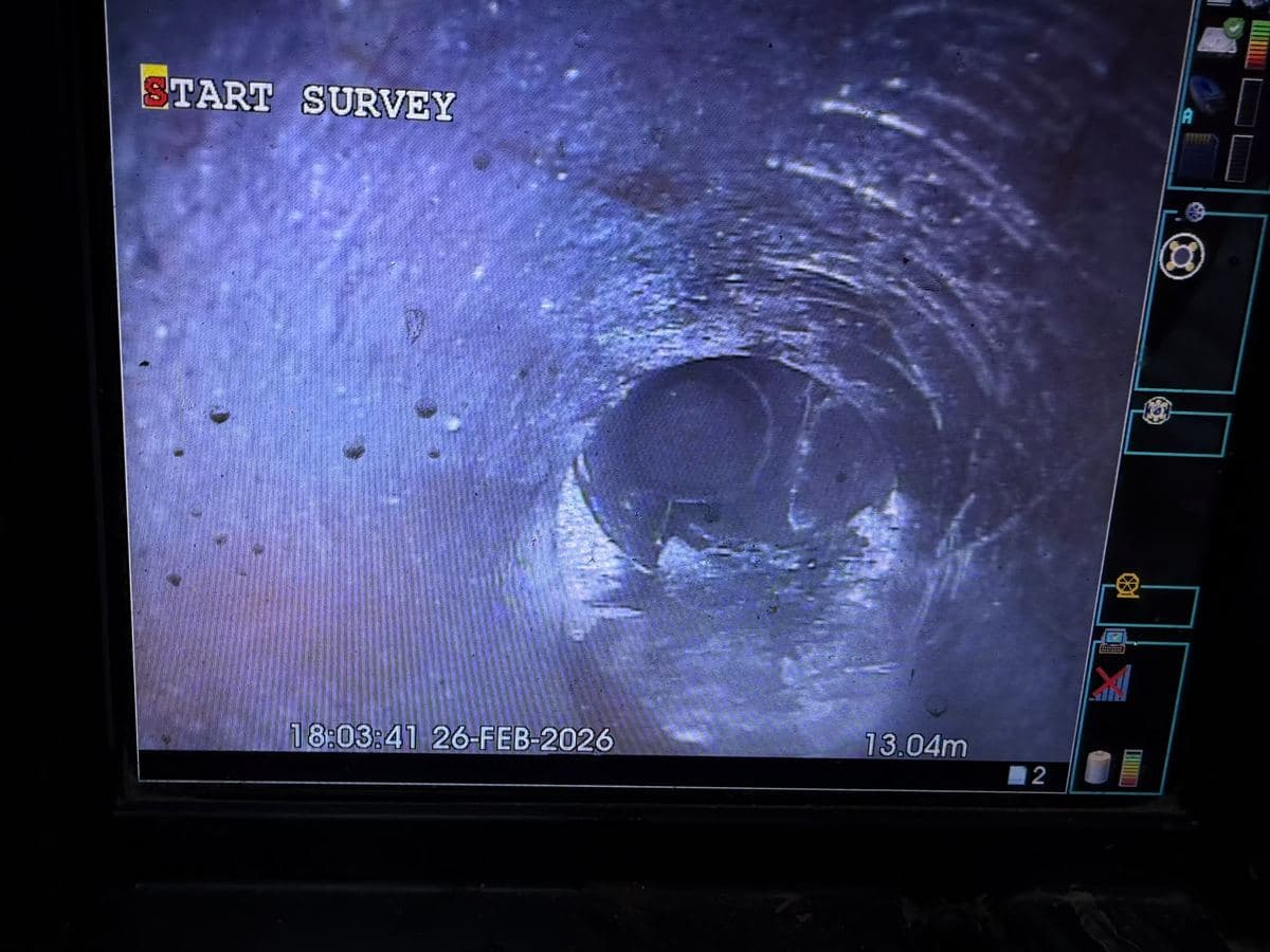 CCTV drain survey monitor showing the inside of a drain pipe