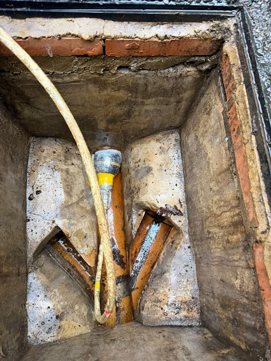 Jetting hose working in a freshly cleared inspection chamber