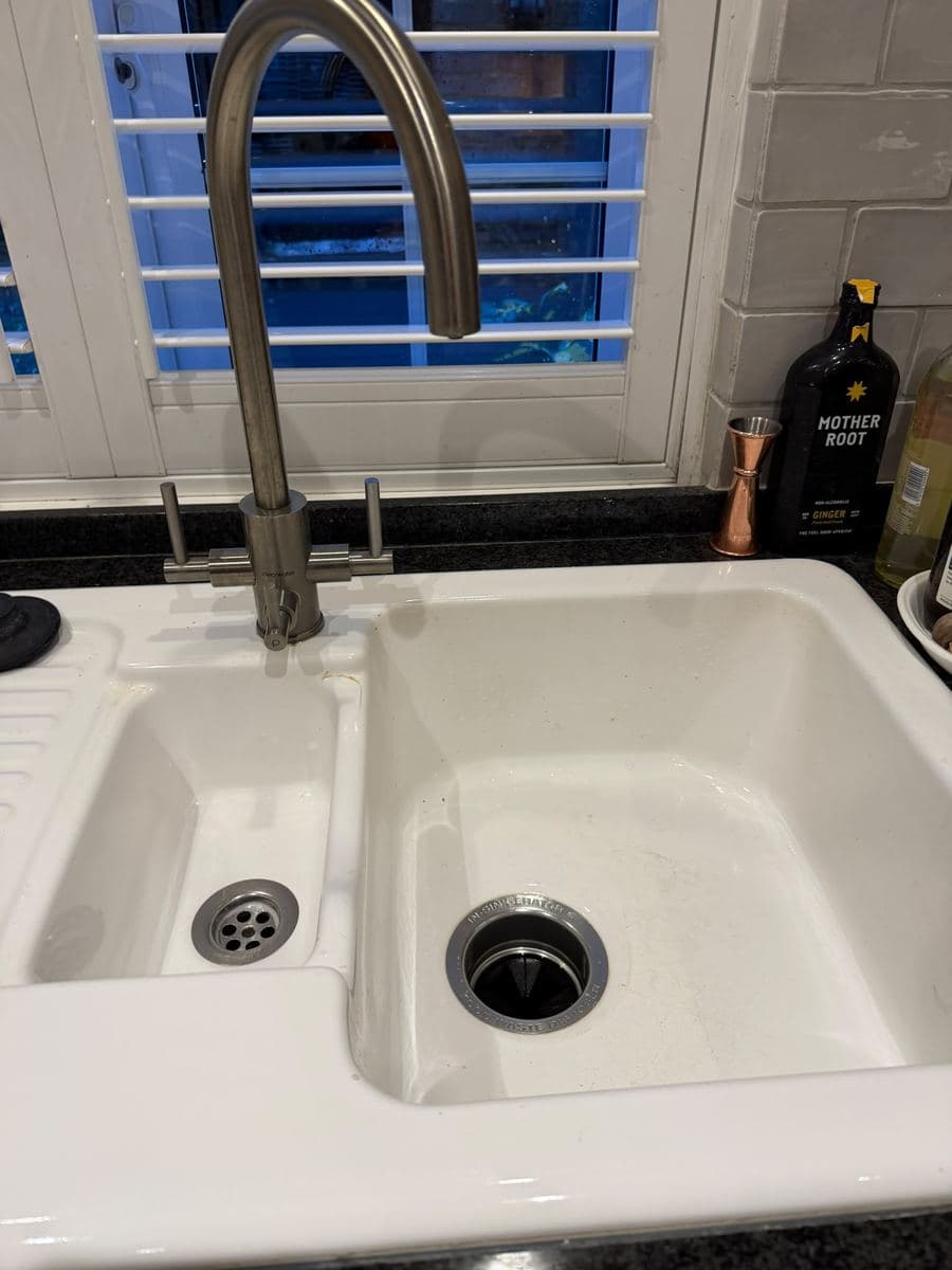 Kitchen sink draining freely after a blockage was cleared